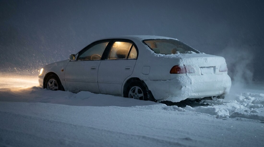 雪に埋もれた車の画像